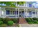 Inviting front porch featuring elegant columns, a porch swing, and a welcoming atmosphere at 2607 White Pines Ct, Monroe, NC 28112