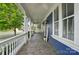 Spacious front porch with stone flooring, ceiling fans, and views of the surrounding neighborhood at 2607 White Pines Ct, Monroe, NC 28112