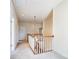 View of upstairs hallway with carpet, wood trim railing, and doors leading to various rooms at 2607 White Pines Ct, Monroe, NC 28112