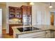 Kitchen features a glass cabinet, granite countertops, tile backsplash and stainless oven at 2607 White Pines Ct, Monroe, NC 28112