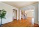 Spacious living room with hardwood floors, detailed trim work, and staircase access to the upper level at 2607 White Pines Ct, Monroe, NC 28112