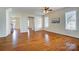 Spacious living room featuring hardwood floors, a ceiling fan, and natural light at 2607 White Pines Ct, Monroe, NC 28112