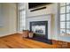 Cozy living room with a modern fireplace, mantle and hardwood floors at 2607 White Pines Ct, Monroe, NC 28112