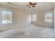 Spacious bedroom featuring neutral walls, large windows, and a ceiling fan at 2607 White Pines Ct, Monroe, NC 28112