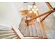 Carpeted staircase with white risers, and dark wood handrail at 2607 White Pines Ct, Monroe, NC 28112