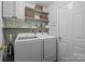 Laundry room with washer, dryer, and shelving at 3000 Trellis Ln, Monroe, NC 28110