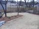 Landscaped backyard with pine straw and new plantings at 303 Gurley St, Kannapolis, NC 28081