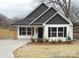 Craftsman style home with white siding and dark roof at 303 Gurley St, Kannapolis, NC 28081