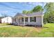 Inviting single-story home with gray siding, black shutters, and a charming front porch at 3321 15Th Sw Ave, Hickory, NC 28602