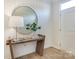Modern entryway with wood console table and round mirror at 5004 Rill Ct # 37, Charlotte, NC 28262