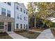 Two-story townhome with gray siding, brick accents, and a front yard at 5004 Rill Ct # 37, Charlotte, NC 28262