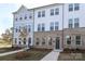Modern townhome with gray siding and brick accents at 5004 Rill Ct # 37, Charlotte, NC 28262