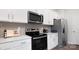 Clean kitchen features stainless steel appliances and white cabinetry at 5067 Beargrass Dr, Dallas, NC 28034
