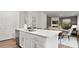 Modern kitchen island with white cabinets and stainless steel appliances at 5067 Beargrass Dr, Dallas, NC 28034