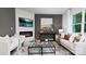 Living room features a fireplace, comfy seating, and large windows at 5067 Beargrass Dr, Dallas, NC 28034