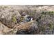 Aerial view of a house on a wooded lot with a long driveway at 5528 Brickstone Dr, Charlotte, NC 28227
