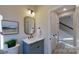 Powder room with a blue vanity, gold mirror, and white countertop at 5528 Brickstone Dr, Charlotte, NC 28227