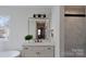 Bathroom with vanity, modern mirror, and marble shower at 5528 Brickstone Dr, Charlotte, NC 28227