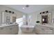 Modern bathroom with double vanity, freestanding tub, and natural light at 5528 Brickstone Dr, Charlotte, NC 28227