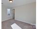 Bedroom with window, carpet, and access to bathroom at 5528 Brickstone Dr, Charlotte, NC 28227