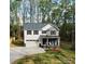 Charming two-story home with a covered front porch and an attached garage, surrounded by trees at 5528 Brickstone Dr, Charlotte, NC 28227