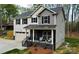 Two-story home featuring a covered front porch, attached garage, and neutral color scheme at 5528 Brickstone Dr, Charlotte, NC 28227