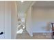 Light-filled hallway with wood flooring, leading to living areas at 5528 Brickstone Dr, Charlotte, NC 28227