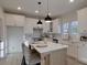 Elegant kitchen with white cabinets, large island, and stylish pendant lighting at 5528 Brickstone Dr, Charlotte, NC 28227