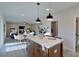 Open concept kitchen features island with white countertops and light wood cabinets at 5528 Brickstone Dr, Charlotte, NC 28227
