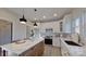 Modern kitchen with white cabinets, marble island, and stainless steel appliances at 5528 Brickstone Dr, Charlotte, NC 28227