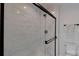 Shower with marble tile and frameless glass door at 5528 Brickstone Dr, Charlotte, NC 28227