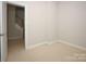 Bedroom featuring neutral walls, carpet and a door leading to the stairway at 5727 Chalyce Ln, Charlotte, NC 28270