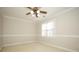 Empty bedroom showcases neutral walls, carpeting, white trim, and a ceiling fan at 5727 Chalyce Ln, Charlotte, NC 28270