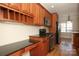 Modern kitchen featuring stainless steel appliances, cherry cabinets, and ample counter space at 5727 Chalyce Ln, Charlotte, NC 28270