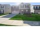 Two-story house with brown siding, two-car garage, and landscaped lawn at 7418 Irwin Rd, Charlotte, NC 28215