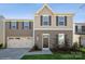 Two-story house with brown siding, two-car garage, and landscaped lawn at 7418 Irwin Rd, Charlotte, NC 28215