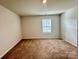 Simple bedroom with neutral walls and carpet at 8112 Derby Woods Ln, Charlotte, NC 28214