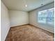 Bright bedroom with neutral walls and carpet at 8112 Derby Woods Ln, Charlotte, NC 28214
