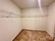 Walk-in closet with wire shelving at 8112 Derby Woods Ln, Charlotte, NC 28214