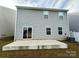 Gray vinyl-sided house with a small patio and AC unit at 8112 Derby Woods Ln, Charlotte, NC 28214