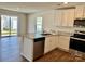 Kitchen with island, granite countertops, and access to backyard at 8112 Derby Woods Ln, Charlotte, NC 28214