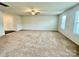 Large living room with neutral carpet and ceiling fan at 8112 Derby Woods Ln, Charlotte, NC 28214