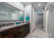 Double vanity bathroom with granite countertops and large mirror at 8176 Viscount Ct, Denver, NC 28037