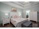 Main bedroom with white wooden bed frame and coastal decor at 8176 Viscount Ct, Denver, NC 28037