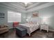 Main bedroom with a white bed frame, coastal decor, and a ceiling fan at 8176 Viscount Ct, Denver, NC 28037