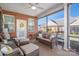 Relaxing screened porch with wicker furniture at 8176 Viscount Ct, Denver, NC 28037