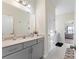 Modern bathroom with gray vanity and a view into a bedroom at 10045 Carousel Corral Dr, Midland, NC 28107