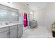 Double vanity bathroom with marble floors and shower at 10045 Carousel Corral Dr, Midland, NC 28107