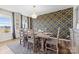 Spacious dining room with a large wooden table, geometric wallcovering, and chandelier at 10045 Carousel Corral Dr, Midland, NC 28107