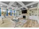 Spacious Gathering room features a stone fireplace, built-in shelving, and large windows at 10045 Carousel Corral Dr, Midland, NC 28107